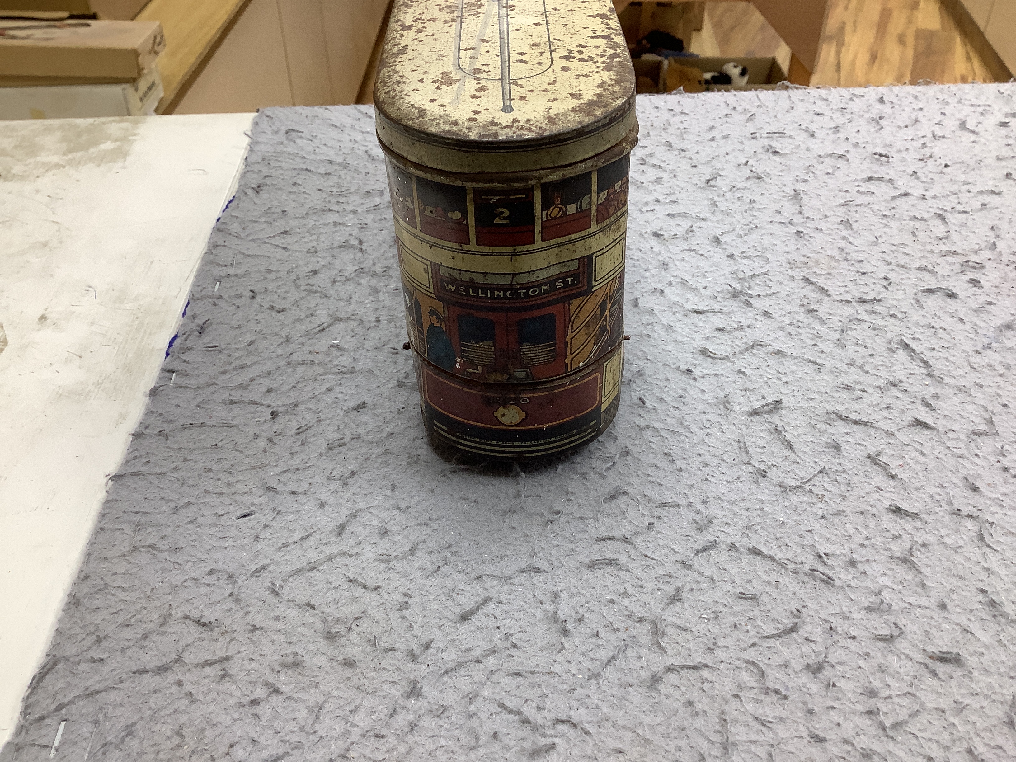 Three tinplate/cast iron toys; a Jaeger cast iron concrete mixer, a Carr’s tinplate biscuit tin in the form of a tram, and a clockwork teddy bear on a tricycle, tram 22cm long